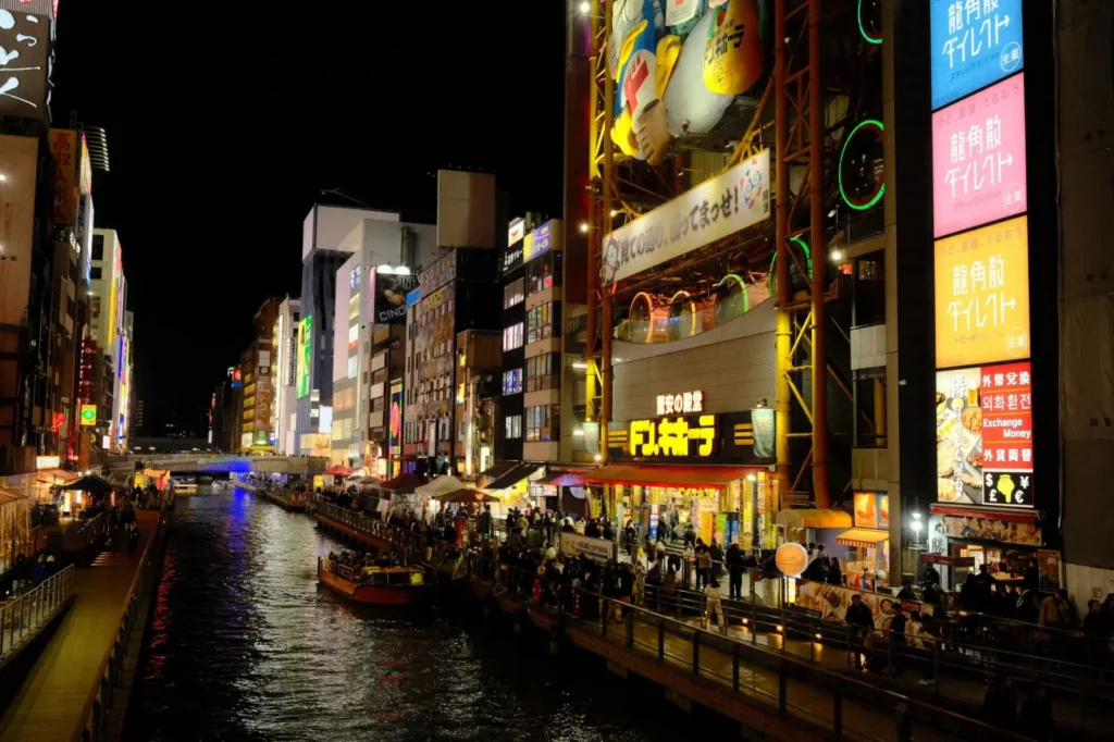 Neon-lit street scene with izakayas in Osaka's Dotonbori