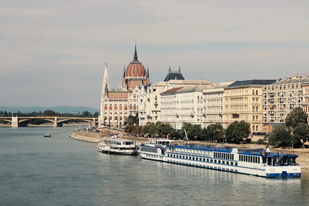 A Danube river cruise ship passing through scenic medieval towns in Hungary and Austria